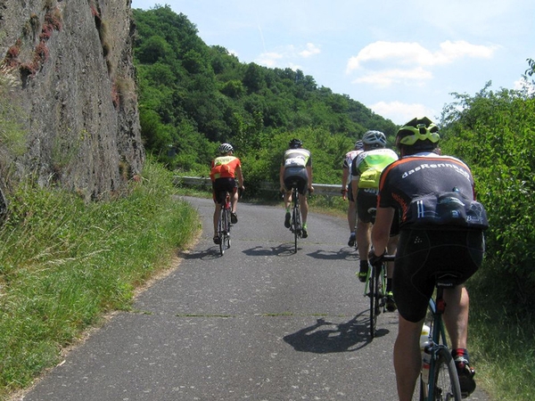 Mehrere Fahrradfahrer fahren eine Straße in der Natur entlang, Bild von Uli Sander.