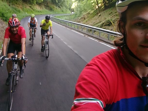 Ein Selfie von mehreren Fahrradfahren, die eine Straße herunterfahren.